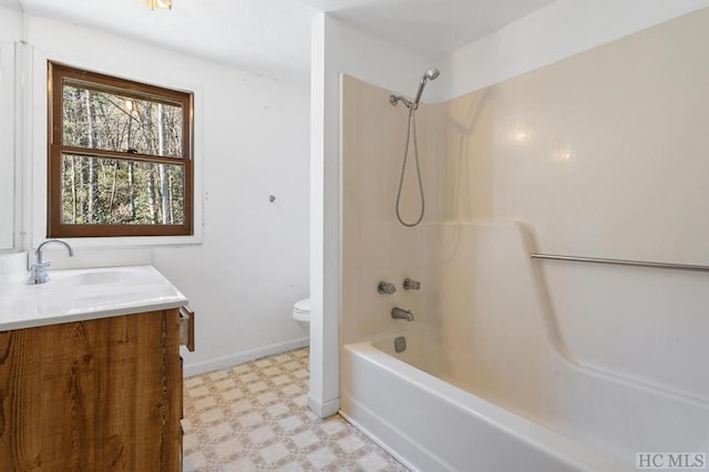 full bathroom featuring vanity, bathing tub / shower combination, and toilet