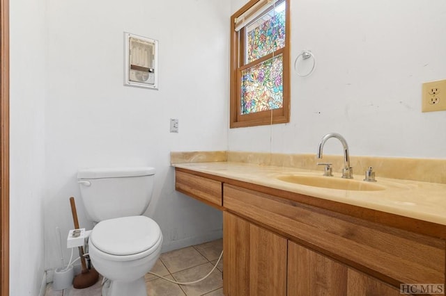 bathroom featuring tile patterned floors, vanity, and toilet