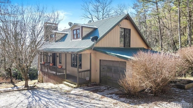 view of home's exterior with a garage and a porch