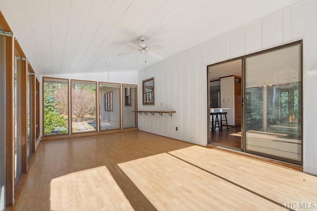 unfurnished sunroom with wood ceiling, ceiling fan, and vaulted ceiling