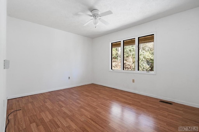 spare room featuring hardwood / wood-style floors, a textured ceiling, and ceiling fan