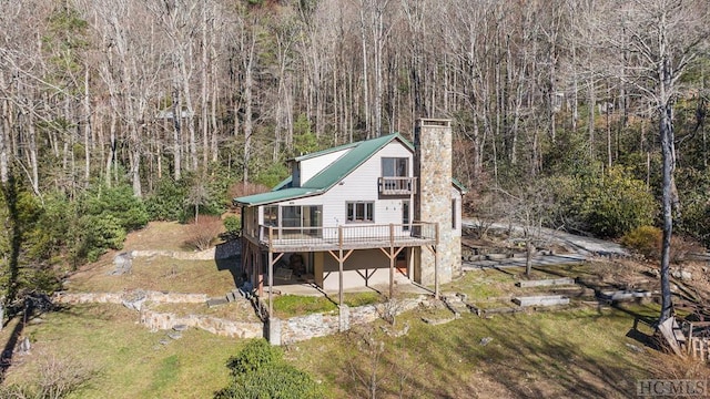 back of property featuring a yard and a deck