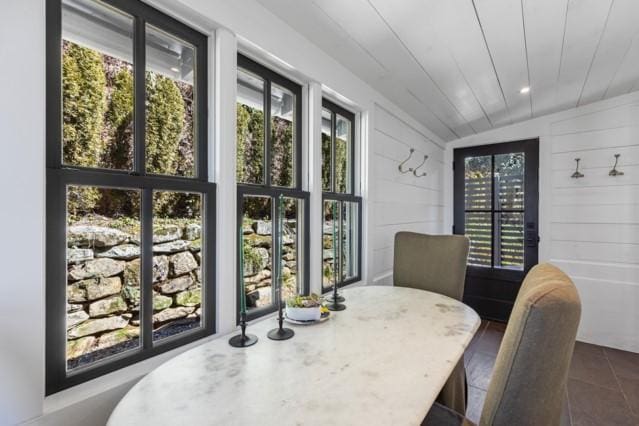 dining area featuring dark tile patterned flooring
