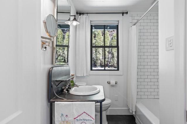 bathroom with shower / tub combo, vanity, and toilet
