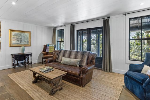 living area with a healthy amount of sunlight, wood finished floors, baseboards, and recessed lighting