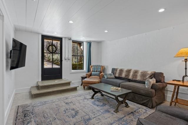 living room featuring baseboards and recessed lighting