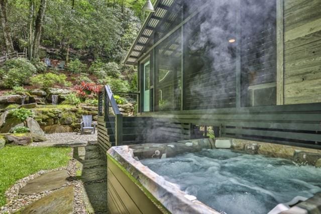 view of home's exterior featuring a hot tub