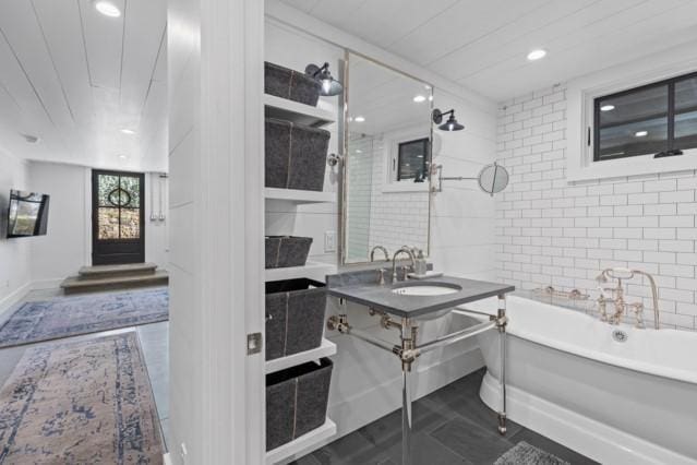 full bath with a shower, a soaking tub, vanity, and recessed lighting