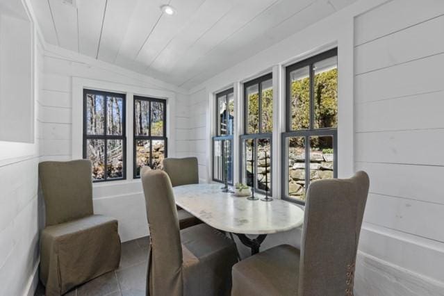 dining space with lofted ceiling and a wealth of natural light