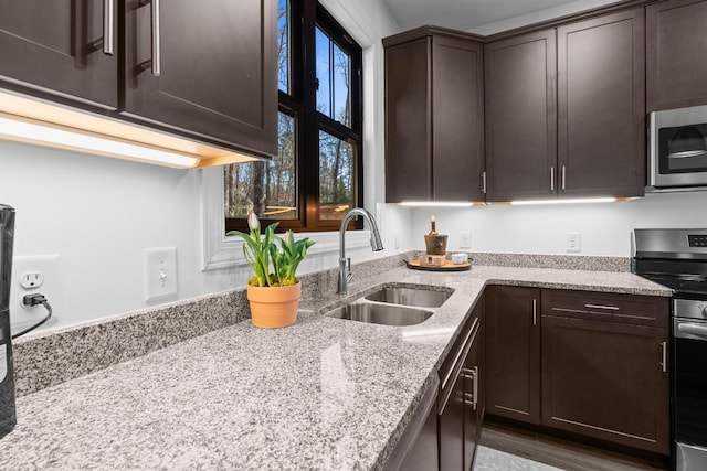 149 Woodland Hill Dr, Highlands, NC 28741 - kitchen with light stone countertops, stainless steel appliances, dark brown cabinets, and a sink