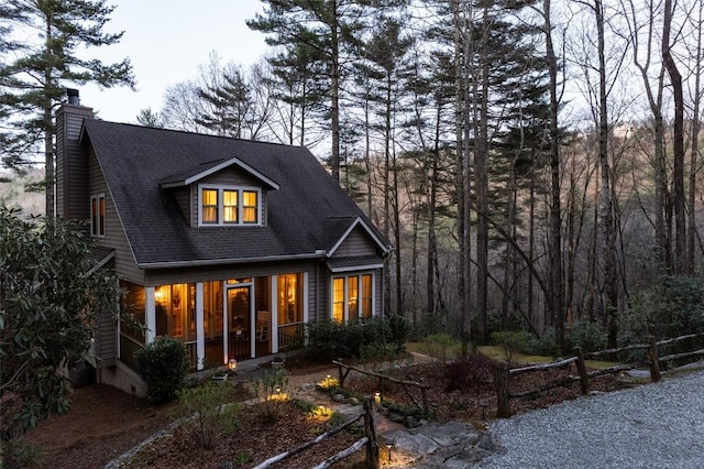 53 Rocky Top Dr, Cashiers, NC 28717 - view of front of home with a chimney, a sunroom, and roof with shingles