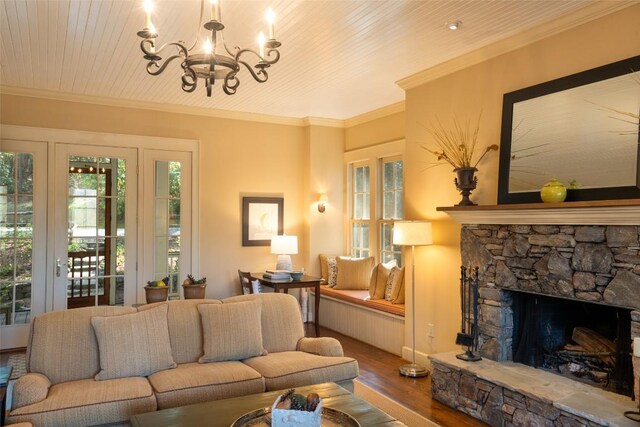 53 Rocky Top Dr, Cashiers, NC 28717 - living room featuring wood finished floors, a chandelier, plenty of natural light, ornamental molding, and a fireplace
