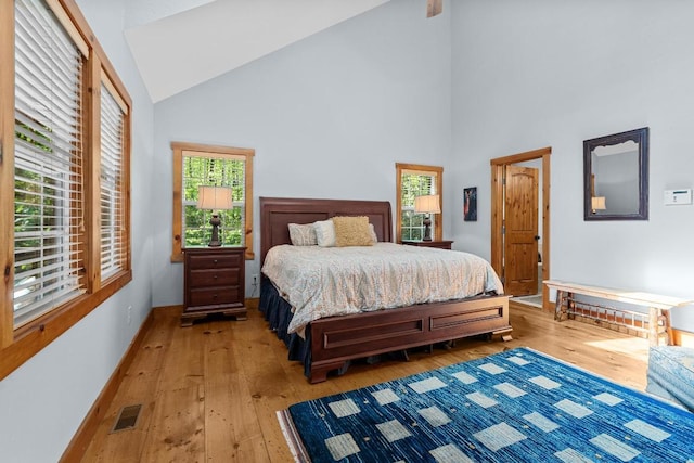 599 Tower Rd, Sapphire, NC 28774 - bedroom with light wood finished floors, high vaulted ceiling, and baseboards