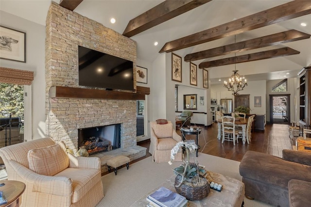 living area featuring a wealth of natural light, a fireplace, an inviting chandelier, and wood finished floors