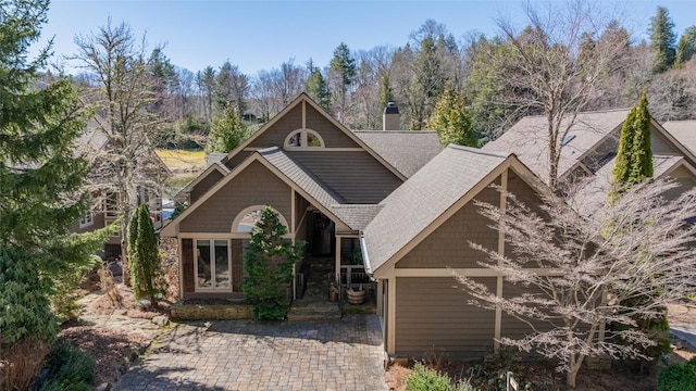 craftsman house with a chimney and a shingled roof