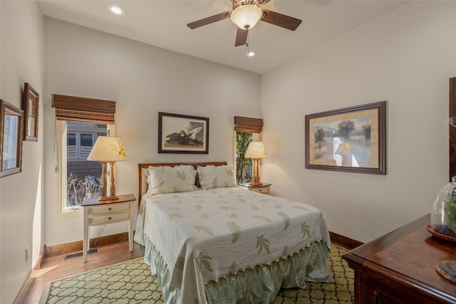 bedroom featuring visible vents, a ceiling fan, wood finished floors, recessed lighting, and baseboards