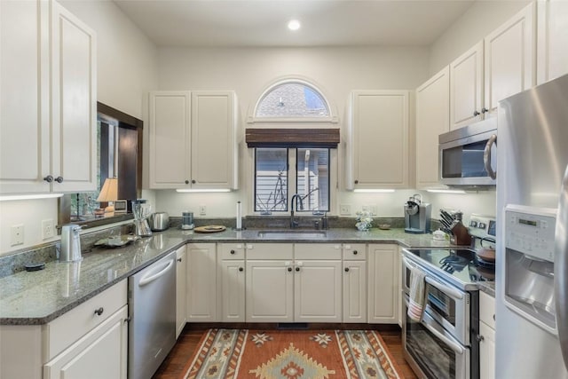 kitchen featuring a sink, stainless steel appliances, and white cabinets