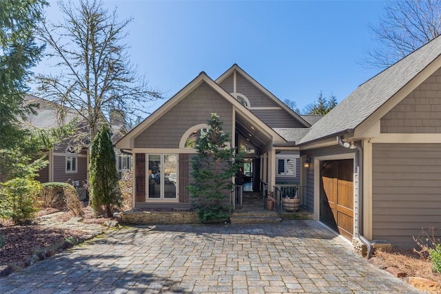 view of front of house featuring roof with shingles and an attached garage