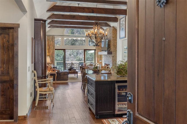 interior space with dark wood-type flooring, beverage cooler, beamed ceiling, an inviting chandelier, and high vaulted ceiling