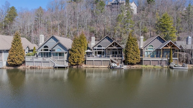 view of dock featuring stairway and a deck with water view