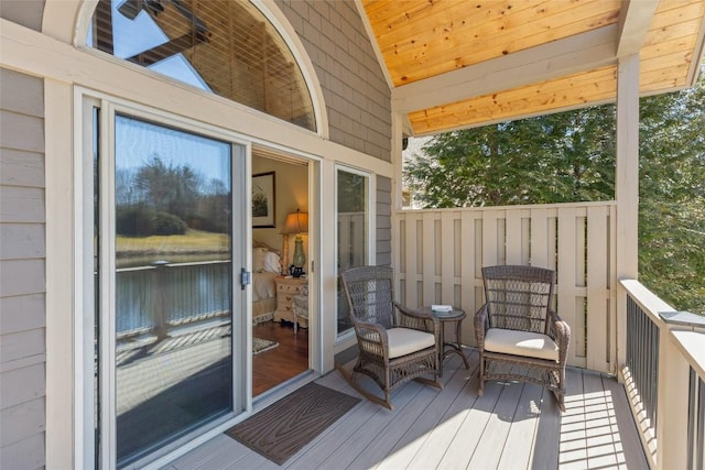 wooden deck featuring a water view