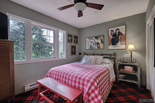 bedroom with ceiling fan and baseboard heating