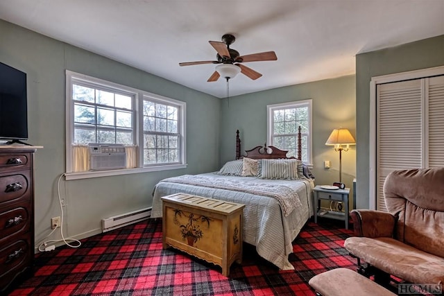 bedroom with a baseboard heating unit, a closet, cooling unit, and ceiling fan