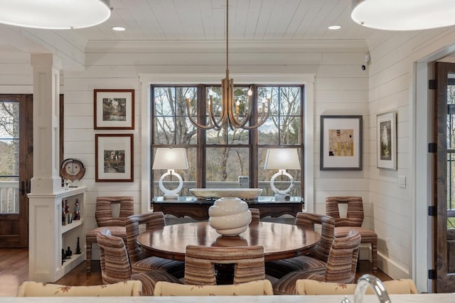 542 Cross Creek Trl, Cullowhee, NC 28723 - dining space with crown molding, wood finished floors, a chandelier, ornate columns, and wooden walls