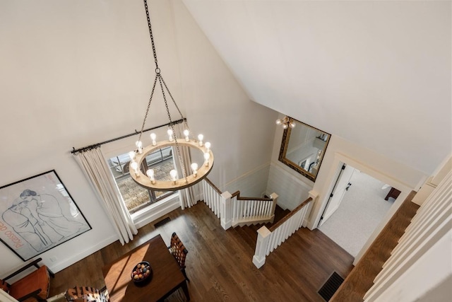 542 Cross Creek Trl, Cullowhee, NC 28723 - stairs featuring a chandelier, wood finished floors, high vaulted ceiling, and baseboards