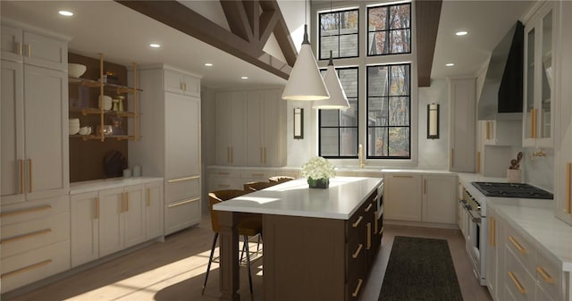 1108 Flagstone Rd, Cashiers, NC 28717 - kitchen with wall chimney exhaust hood, gas range, a center island, light countertops, and recessed lighting