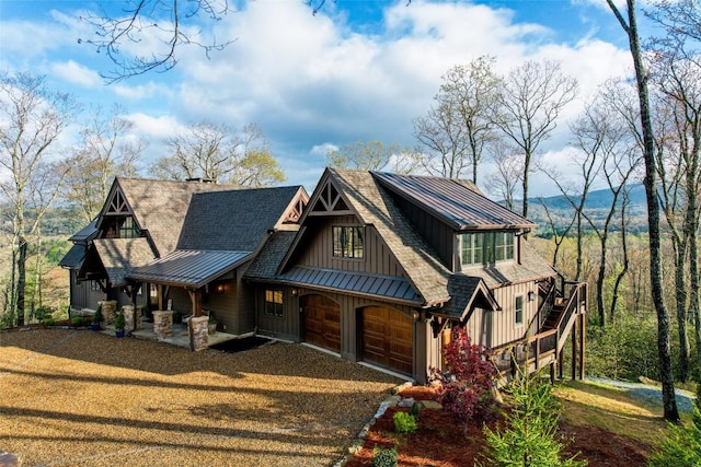 craftsman-style house with roof with shingles, a standing seam roof, board and batten siding, an attached garage, and a porch
