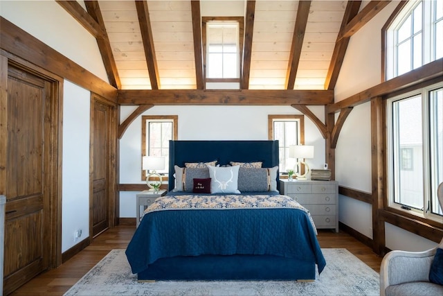 bedroom with vaulted ceiling with beams, baseboards, wood finished floors, and wooden ceiling