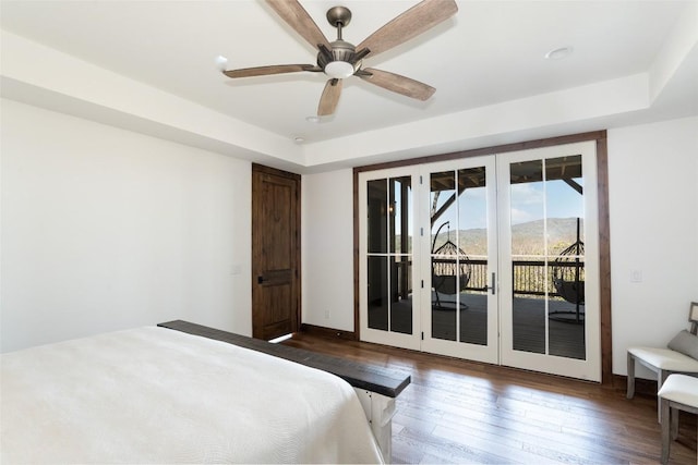 bedroom featuring access to outside, a ceiling fan, dark wood finished floors, and french doors