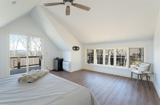 bedroom with baseboards, lofted ceiling, wood finished floors, and access to exterior