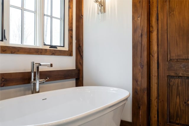 bathroom with a sink and a freestanding bath