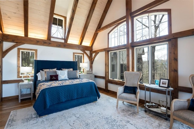 bedroom featuring baseboards, multiple windows, high vaulted ceiling, and beamed ceiling