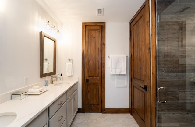 bathroom featuring double vanity, visible vents, a sink, and a stall shower