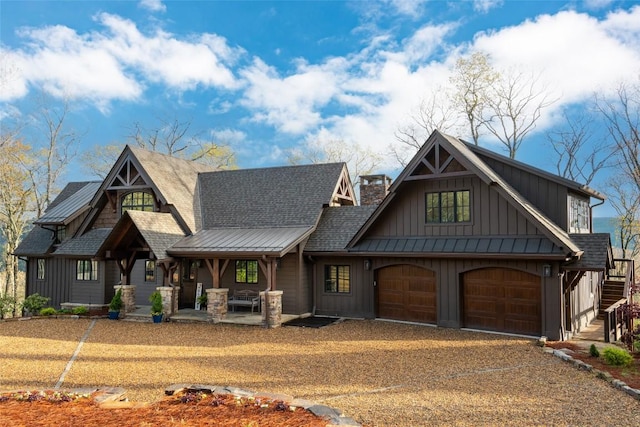 craftsman-style house featuring a garage, dirt driveway, board and batten siding, a porch, and stairway