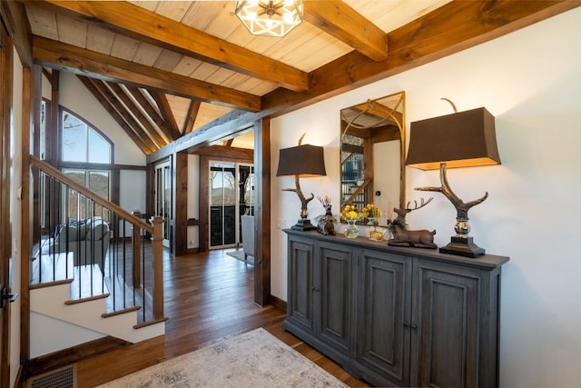 foyer with visible vents, wood finished floors, wooden ceiling, vaulted ceiling with beams, and stairs