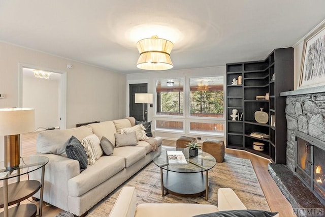 living room featuring hardwood / wood-style floors and a stone fireplace