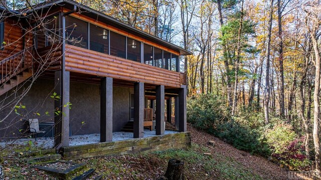 rear view of house with a sunroom and a patio area