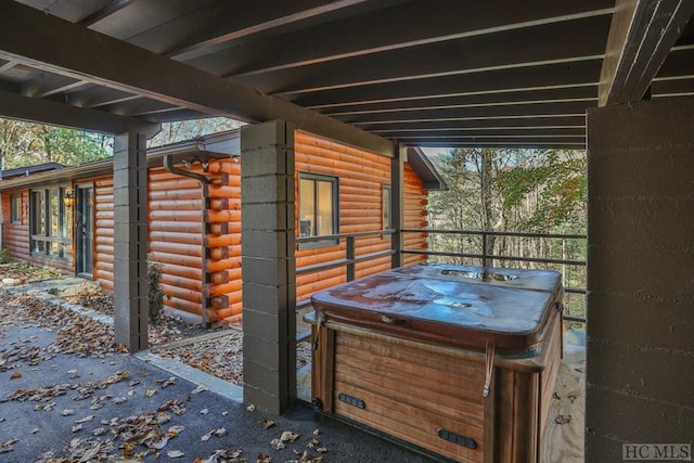 view of patio / terrace with a hot tub