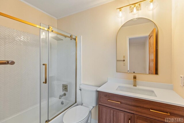 full bathroom with vanity, ornamental molding, toilet, and combined bath / shower with glass door