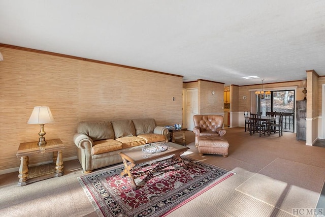 carpeted living room with crown molding and a notable chandelier