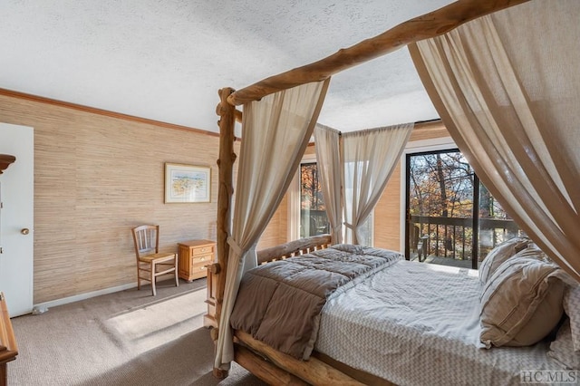 carpeted bedroom featuring a textured ceiling and access to outside