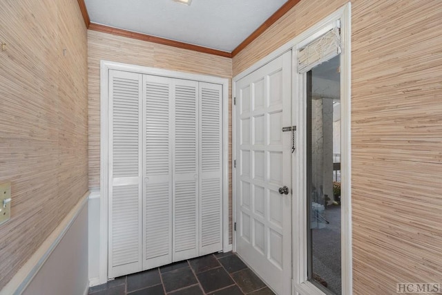 doorway to outside with ornamental molding and wood walls