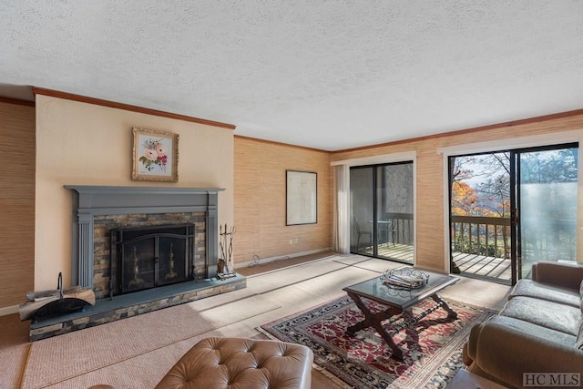 living room with light carpet, a fireplace, ornamental molding, and a textured ceiling