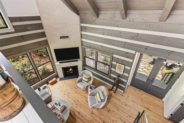 42 W Black Rock Cir, Highlands, NC 28741 - living area featuring wood finished floors, a lit fireplace, a wooden ceiling with exposed beams, and wooden walls