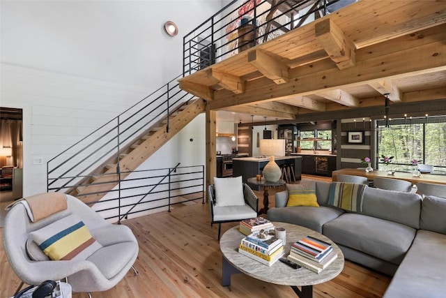 42 W Black Rock Cir, Highlands, NC 28741 - living room with light wood-type flooring, wooden walls, stairway, and beam ceiling