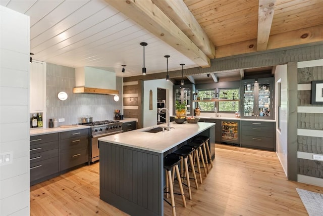 42 W Black Rock Cir, Highlands, NC 28741 - kitchen featuring high end stainless steel range oven, premium range hood, light wood-type flooring, beverage cooler, and a kitchen breakfast bar